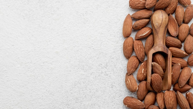 Organic almond nuts and wooden spoon