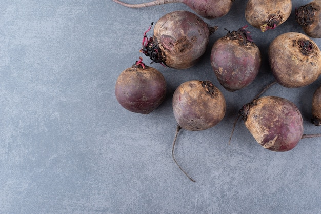 Organic beetroots isolated on concrete surface