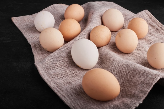 Organic eggs over kitchen towel. 