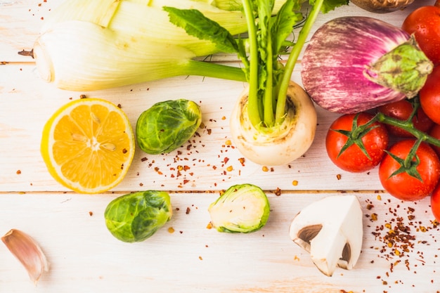 Free Photo organic fresh vegetables with chili flakes on wooden surface