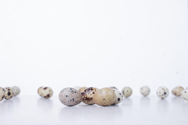 Free Photo organic quail eggs on white surface.