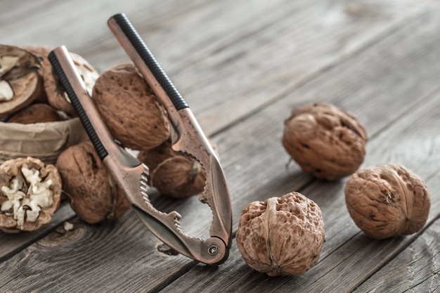 Free photo organic walnut lies on a wooden wall , close-up .