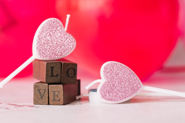 Free Photo ornament candles of symbol of heart near love title of wooden wands