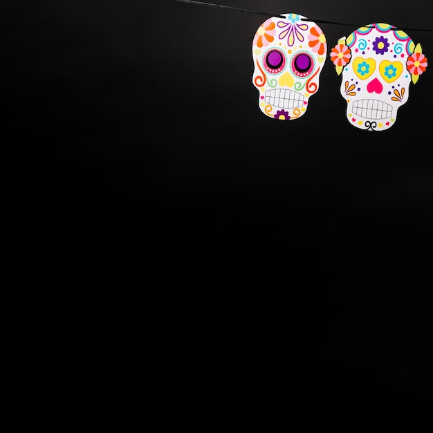 Free photo ornamental painted skulls on black