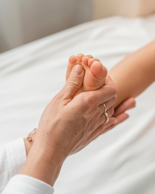 Osteopathist treating a baby girl's feet