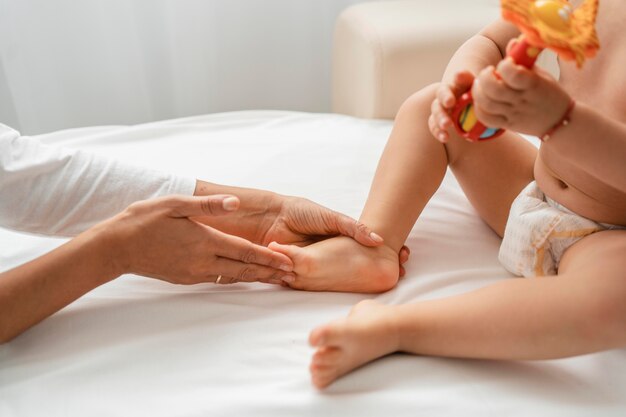 Osteopathist treating a baby girl's feet