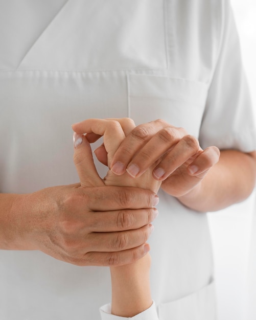 Free photo osteopathist treating a patient's arms