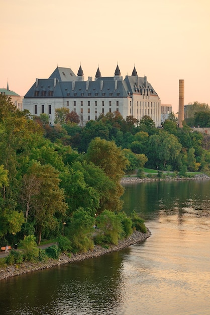 Free photo ottawa sunset over river with historical architecture.