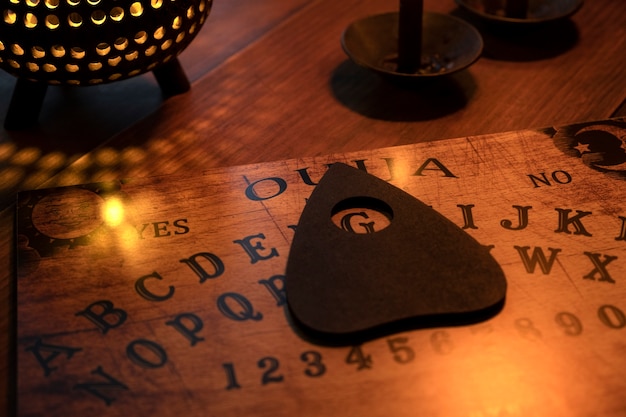 Free Photo ouija board and candle arrangement