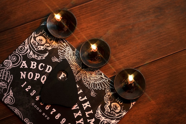 Ouija board and candles arrangement top view