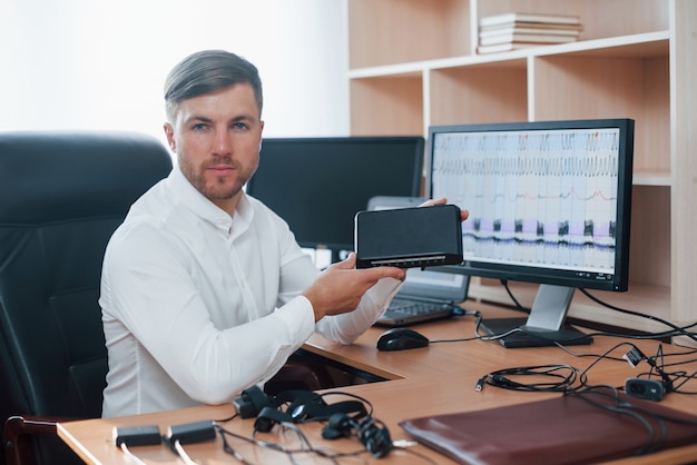 Free Photo our new device. polygraph examiner works in the office with his lie detector's equipment