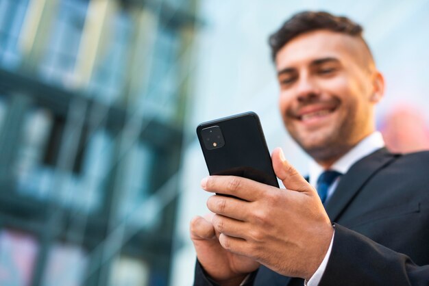 Outdoor businessman using the phone low view