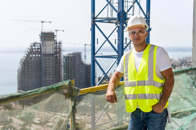 Free photo outdoor construction worker standing at high altitude