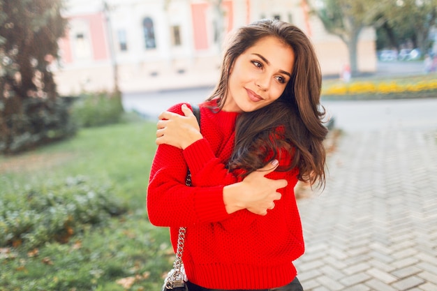 Free Photo outdoor lifestyle portrait of cute smiling woman in warm autumn casual outfit walking in park and enjoying sunny weather. romantic mood.