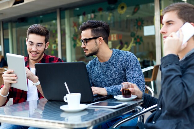 Outdoor portrait of young entrepreneurs working at coffee bar.