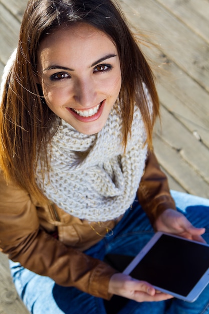 Free Photo outdoor portrait of young woman with digital tablet