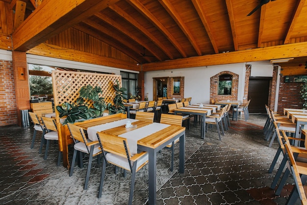 Outdoor restaurant with wooden chairs and tables