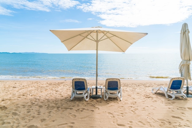 Free photo outdoor with umbrella and chair on beautiful tropical beach and sea