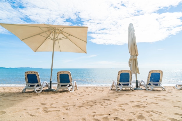 Free photo outdoor with umbrella and chair on beautiful tropical beach and sea