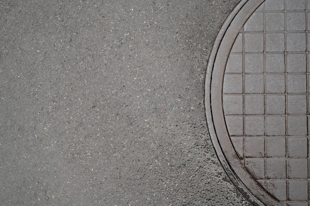 Free photo outdoors cobblestone texture with manhole