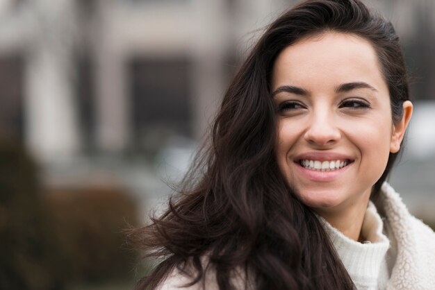 Outdoors portrait of smiley woman