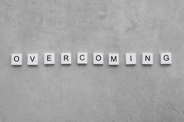 Free photo overcoming text on white cubes arrangement