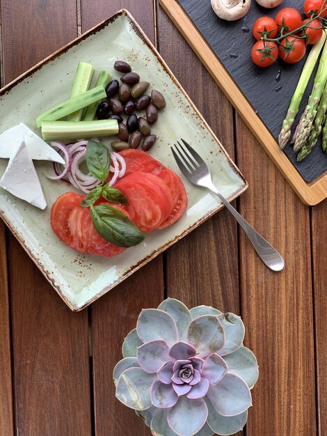 Free Photo overhead closeup shot of a salad with beans and cheese on a square plate with a fork