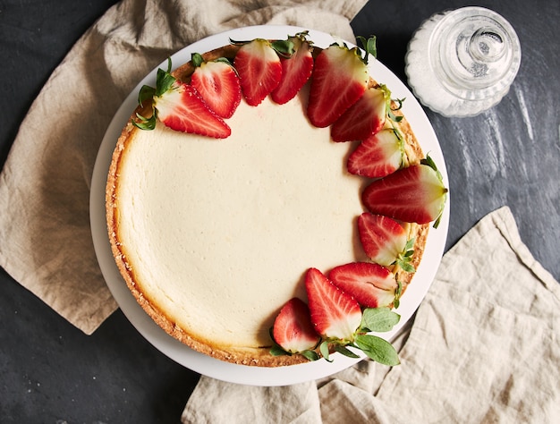 Overhead closeup shot of a Strawberry Cheesecake on a white plate