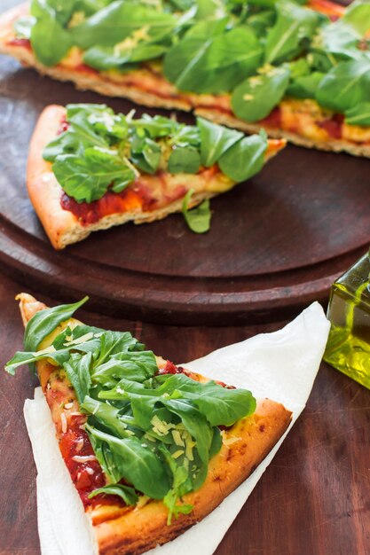 An overhead of pizza slice served on tissue paper