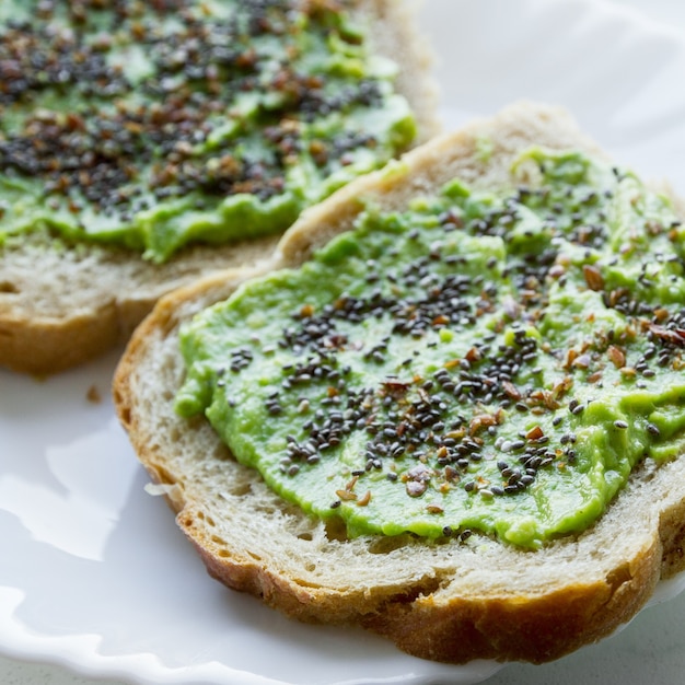 Free photo overhead shot of a bread spread with an avocado cream with chia seeds