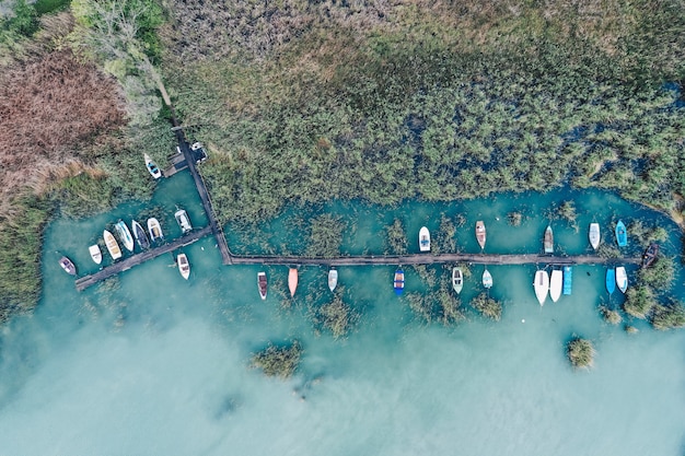 Free Photo overhead shot of a little dock at the coast with parked fishing boats