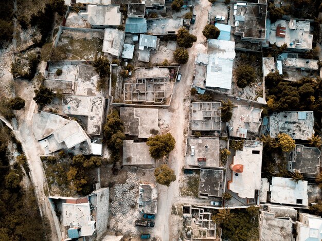 Overhead shot of a road in the middle of old buildings and trees