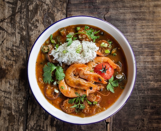 Free photo overhead shot of soup with shrimps and vegetables leaves in a white bowl