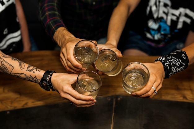 Overhead vie of friends holding glass of cocktails