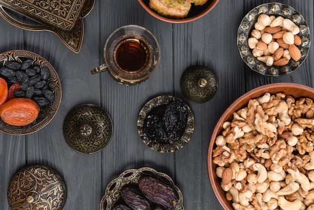 Free photo an overhead view of arabian tea; dried fruits and nuts for ramadan