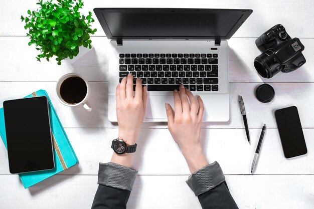 Overhead view of businesswoman working at computer in office. Place for your text. Ideal for blog. Flat lay