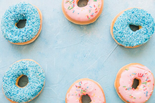 Overhead view of colorful donuts forming frame