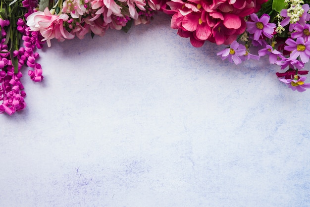 Free Photo an overhead view of colorful flowers on white textured background