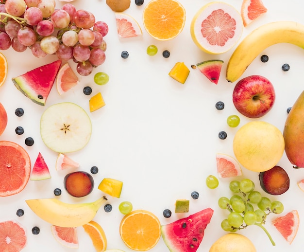 An overhead view of colorful fruits isolated on white background