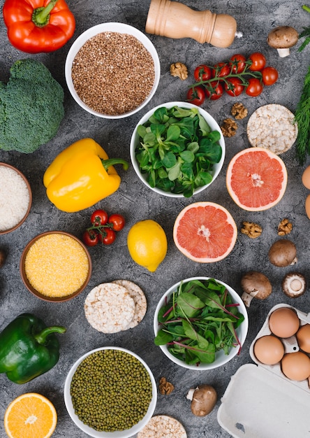 Free photo an overhead view of colorful vegetables and fruits on concrete background