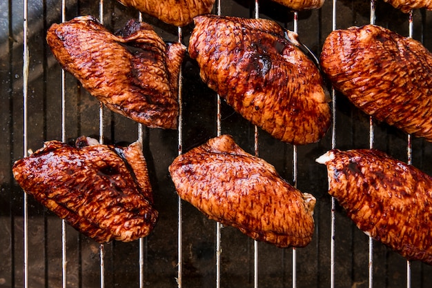 An overhead view of delicious pieces of chicken meat on metal grill