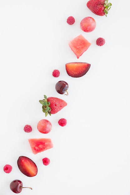 Free Photo an overhead view of diagonal red fruits with copy space for writing text on white background