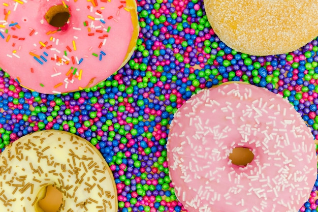 Free photo an overhead view of donuts on the sprinkle balls