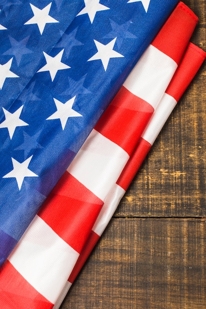 Free photo an overhead view of folded american flag on wooden table