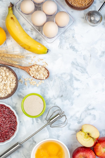 Overhead view of free space and fresh healthy food set on two-toned white blue background