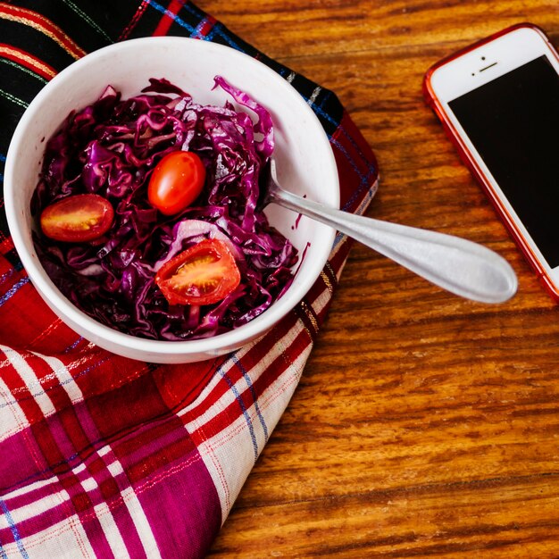 Overhead view of fresh tomatoes and red cabbage in bowl