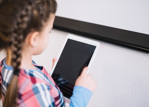 An overhead view of a girl using digital tablet