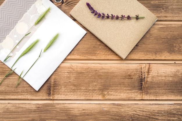 Free Photo overhead view of green ears of wheat on greeting card and lavender twig on wooden table