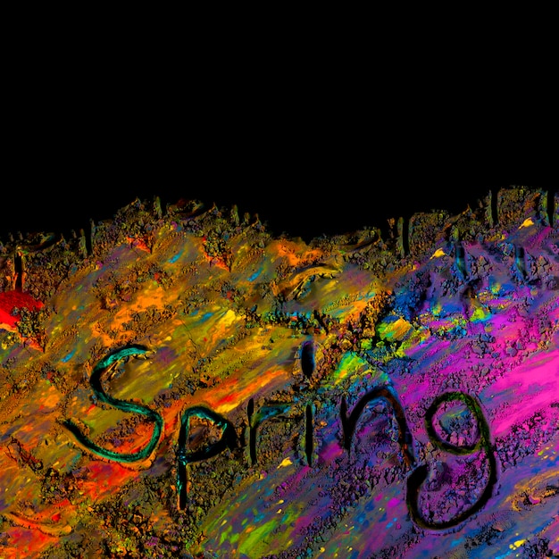 Free photo overhead view of handwritten spring text on colorful holi powder