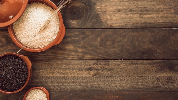 Overhead view of healthy rice grain bowls on wooden table